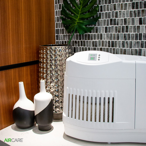 White AIRCARE Mini-Console MA0800 evaporative humidifier with its digital control panel in a staged interior