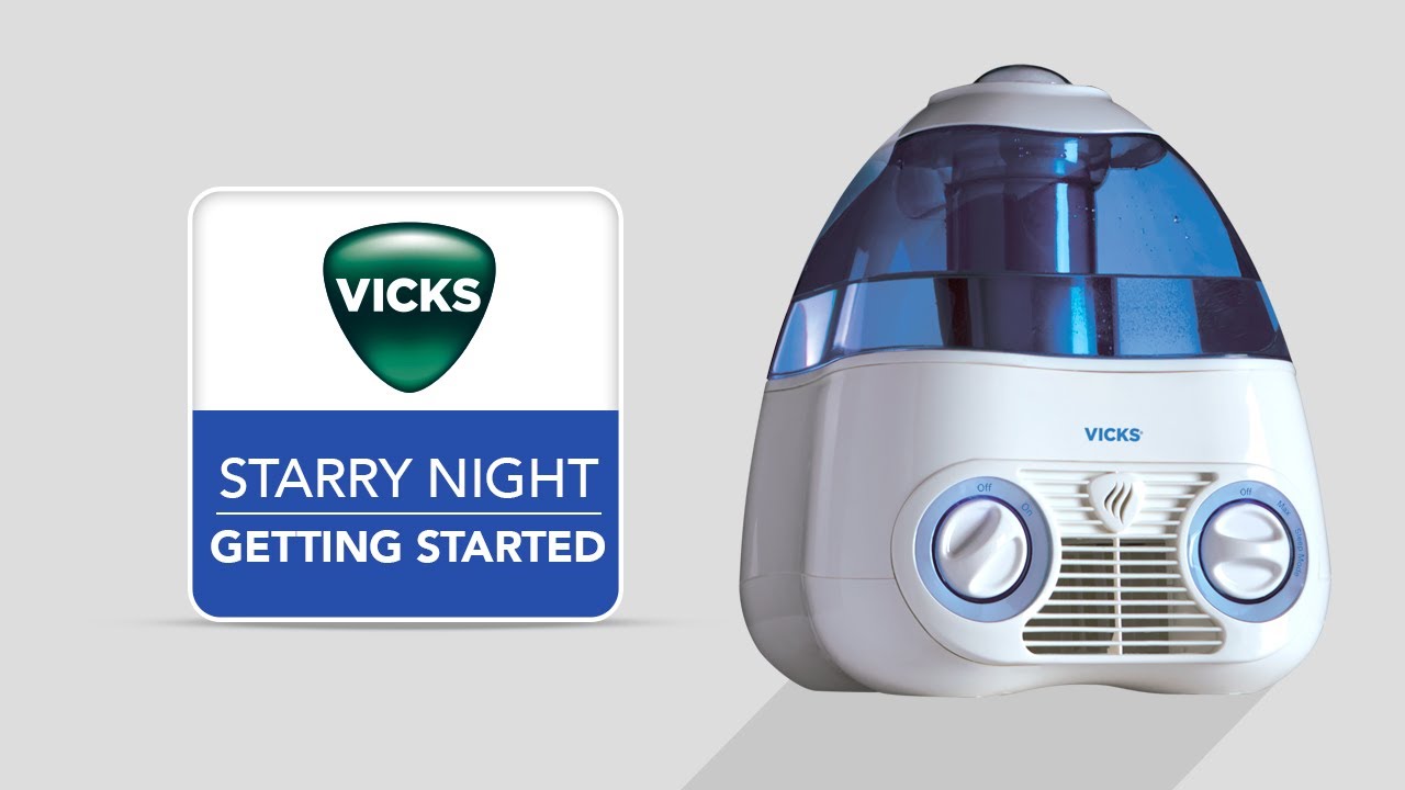 Vicks V3700 Starry Night humidifier with a translucent blue tank, white housing and front controls, shown beside the manufacturer Getting Started title panel